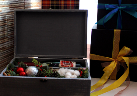 Gray box with gift. A bottle of red wine, spruce branches, Christmas ballsの写真素材