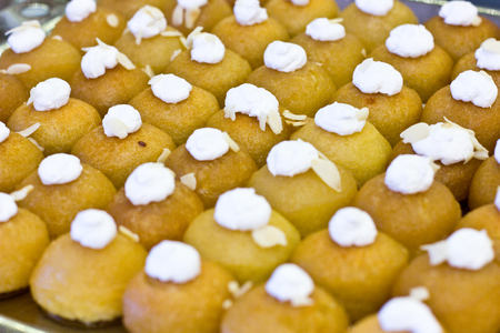 Traditional Turkish dessert Shekerpare with whipped cream. Sliced portioned at hotelの写真素材