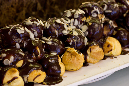 Profiteroles with a chocolate cream and almond chips