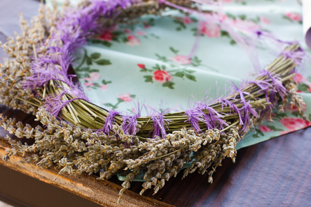 Hair ornament. A delicate wreath of dry lavender on blue tableclothの写真素材
