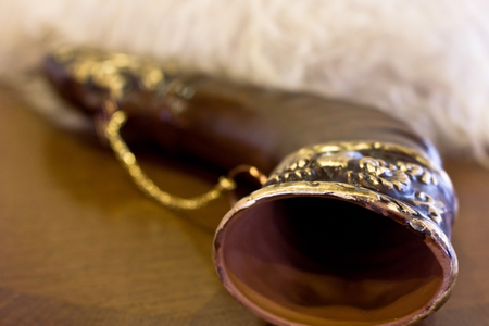 Georgian sheepskin cap made of white sheep's wool, brown horn 'khantzi' for the wineの写真素材