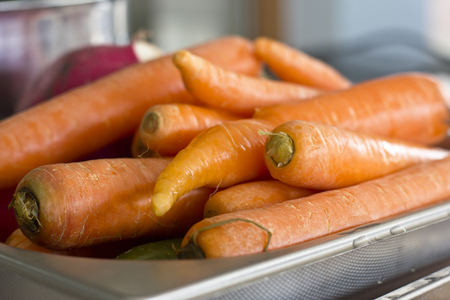 Fresh unclean whole carrots close-up. Selective focusの写真素材