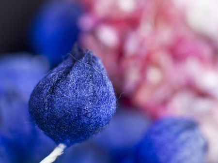 Blue buds and pink lilacs on black background. Artificial flowersの写真素材