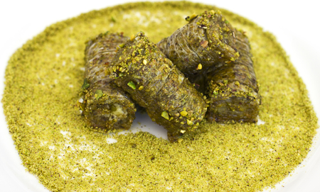 Traditional oriental dessert - baklava with the pistachios and walnuts. Isolated