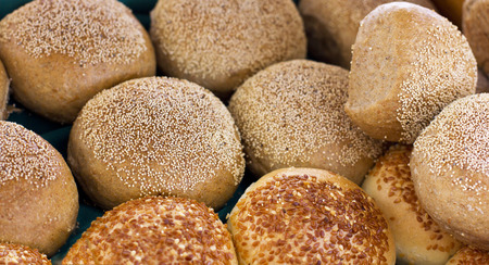 Fresh buns from yeast dough with the sesame and poppy seeds