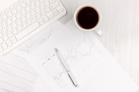 Flat lay of white office desk with laptop, smartphone, eyeglasses, notebook and pen with copy space background. Mockupの写真素材