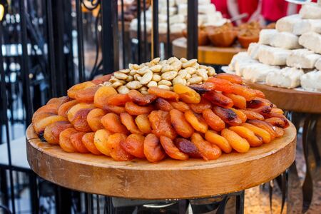 Whole dried apricots with nuts in a potteryの写真素材