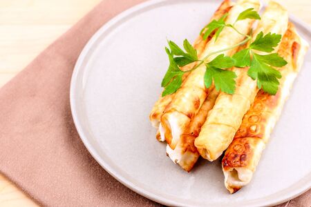 Traditional Turkish Pastries sigara borek - Deep Fried pies with the cottage cheese and parsley.