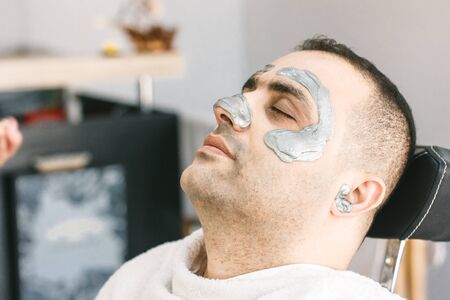 Male face waxing. Barber removes hair by shugaring from face of turkish man.の写真素材
