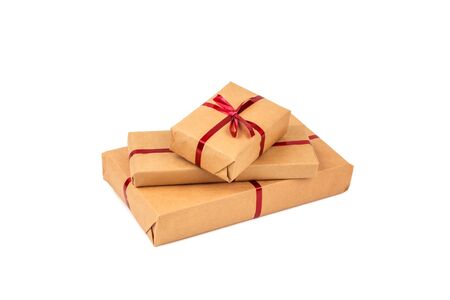 Gift Boxes in Craft Wrapping Paper with the Red Ribbons isolated