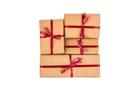 Gift Boxes in Craft Wrapping Paper with the Red Ribbons isolatedの写真素材