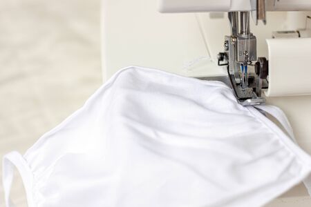 Sewing medical masks to protect against coronavirus. Home production of masks on sewing machine...