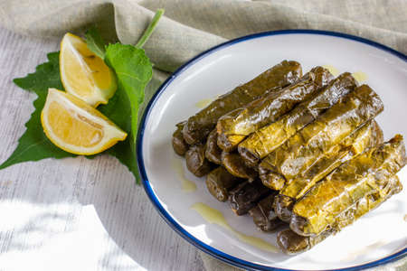 Traditional turkish meal - Yaprak dolma. Grape leaves stuffed withrice and spices. Served with olive oil and fresh lemonの写真素材