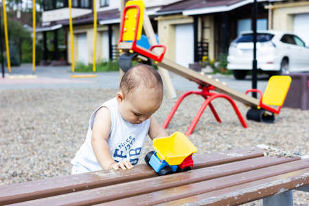 Cute happy smiling baby boy at playground outdoorsの写真素材