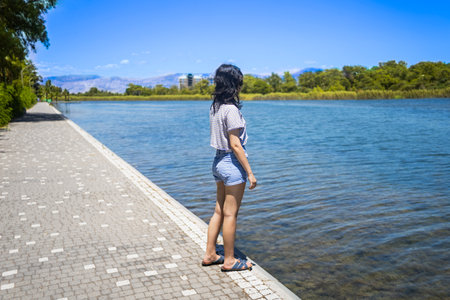A young teen girl on the shore of Titreyen Gol lake in Turkeyの写真素材