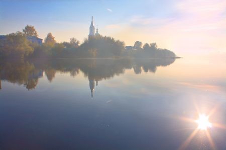 Sunrise on the river in a fogの写真素材