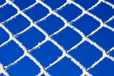 abstract winter background from a lattice against the blue skyの写真素材