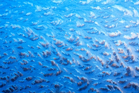 abstract background from frosty pattern on glassの写真素材