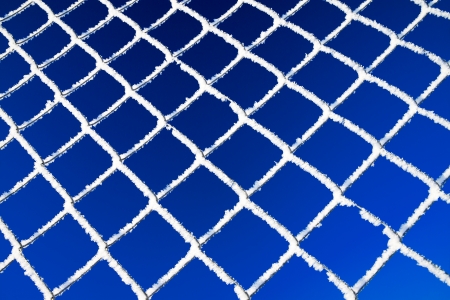abstract winter background from a lattice against the blue skyの写真素材