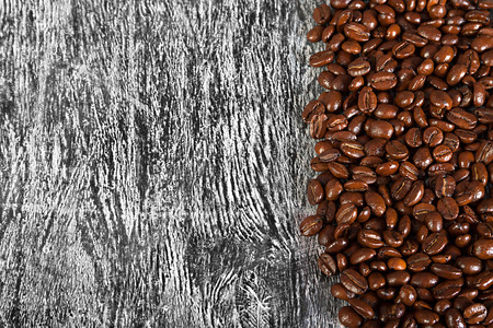 the fried beans of coffee on a wood backgroundの写真素材