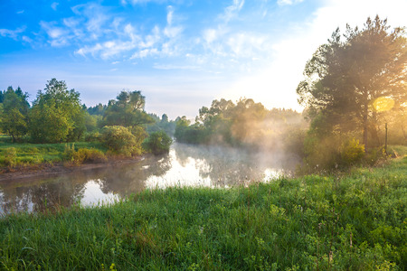 beautiful summer landscape with sunrise over the riverの写真素材