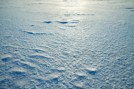 abstract winter background from snow shiny in the sunの写真素材