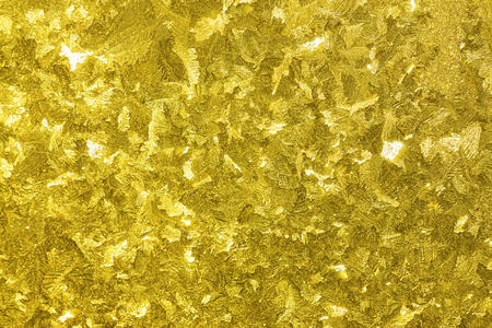 abstract shiny gold  yellow background from a frosty pattern on glassの写真素材