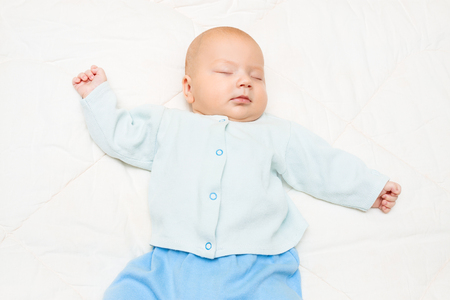 the close up  little baby sleeping on a white backgroundの写真素材