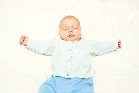 the  little baby sleeping on a white backgroundの写真素材