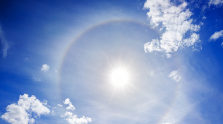 landscape from the blue sky with sun, white clouds and halo.  panorama  view haloの写真素材