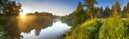 Summer landscape panorama with river and sunrise. Panoramic view with forest and meadowの写真素材