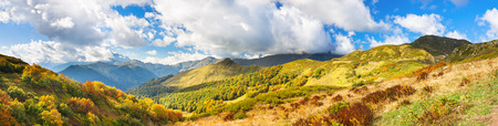 beautiful panorama mountain landscape with blue sky and white clouds. rocky autumn scenery scenic panoramic viewの写真素材