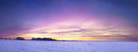 beautiful winter landscape panorama with sunrise. panoramic view with a field of sunshine and blue skyの写真素材