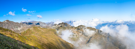 panorama of mountain top landscape. mountain scenery with blue sky and white clouds. panoramic view over  cloudsの写真素材