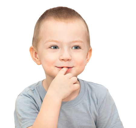 little child boy isolated on white background. child put his finger in his mouthの写真素材