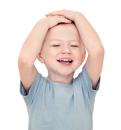 happy little  child smiles isolated on a white background. beautiful small  boy cheerful laughs. kid holds hands on headの写真素材
