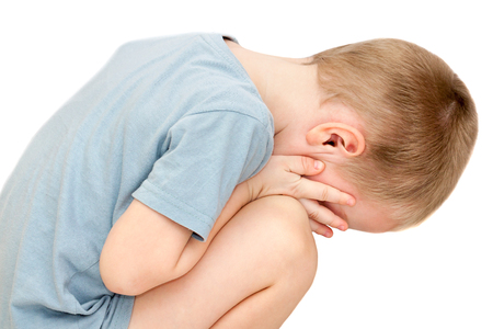 hurt a small child is crying isolated on white background. little boy tears wipes and close face with his handsの写真素材