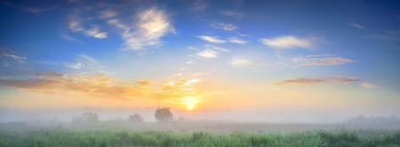 beautiful summer landscape panorama with sunrise and fog. panoramic view of sky and sunsetの写真素材