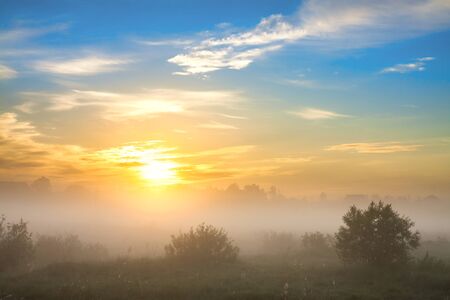 beautiful summer landscape with sunrise and fog. panoramic view of sky and sunsetの写真素材
