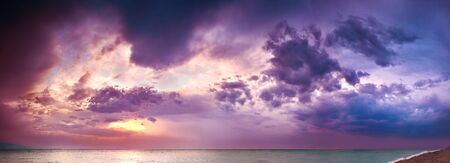 beautiful panorama sea landscape with a sunset. evening purple sky with clouds over ocean. sky with clouds panoramic viewの写真素材