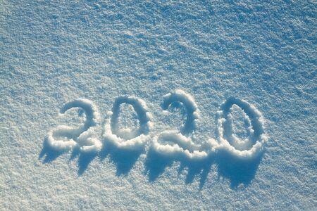 abstract  winter New Year's and Christmas background from snow.text on snow 2020の写真素材