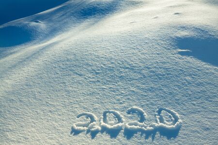 abstract  winter New Year's and Christmas background from snow.text on snow 2020の写真素材