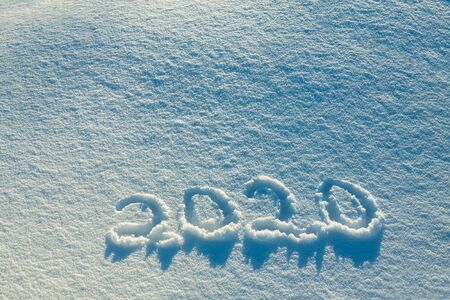 abstract  winter New Year's and Christmas background from snow.text on snow 2020の写真素材