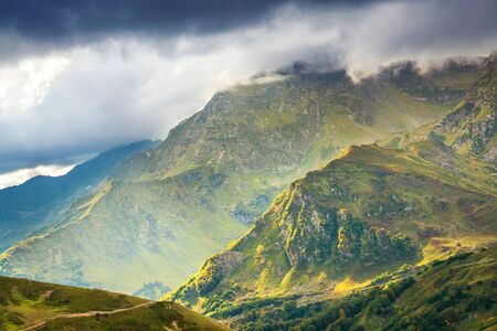beautiful mountain landscape with sky and dark clouds. rocky autumn scenery scenic viewの写真素材
