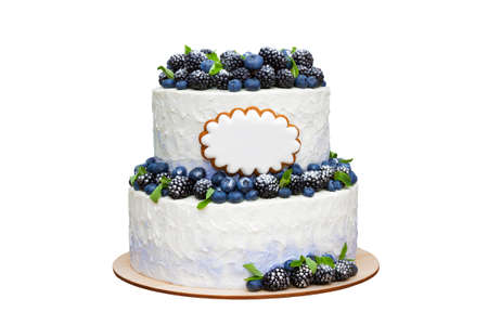 two tiered cake decorated with blueberries and blackberries isolated on a white background. delicious birthday cake with fresh berries and cream cheeseの写真素材