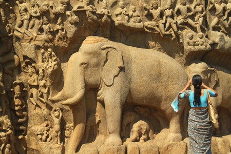Woman photographing ancient carvingsのeditorial素材