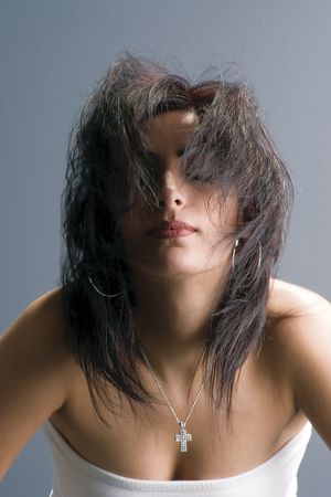 Twenty something fashion model in white tube top, flipping hair back in full motionの写真素材