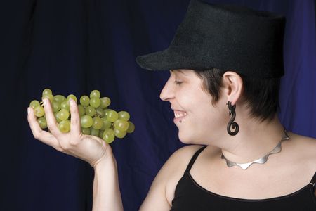 Thirty something model eating green grapesの写真素材