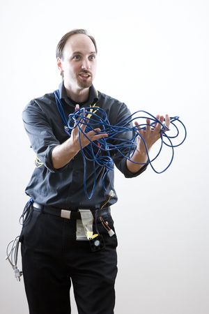 Computer technician looking exaperated showing network cableの写真素材