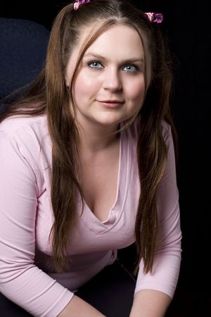 Chubby girl in pink shirt smilingの写真素材